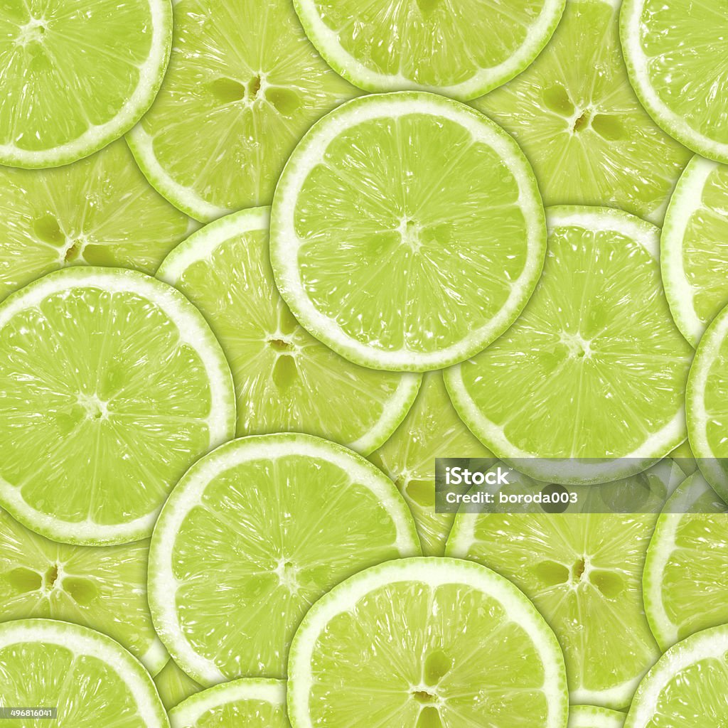 Seamless pattern of green lime slices Abstract background of heap fresh green lime slices. Seamless pattern for your design. Close-up. Studio photography. Lime Stock Photo