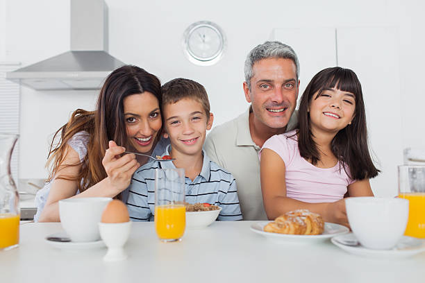 istock Beautiful family eating breakfast in kitchen together 496817469