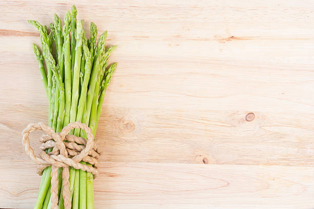 istock Bunch of fresh green asparagus spears tied with string 496818085