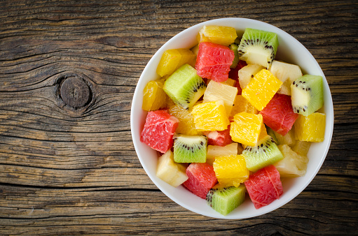 Fresh fruit salad on wooden table