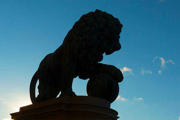 Stone sculpture of lion resting on ball Stockholm,Sweden