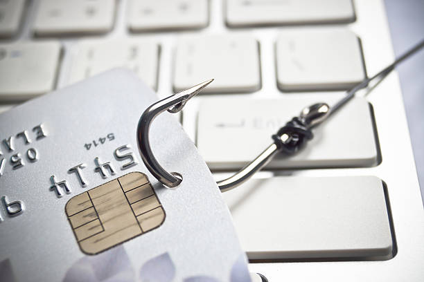 phishing phishing - fish hook with a credit card on white computer keyboard hook equipment photos stock pictures, royalty-free photos & images