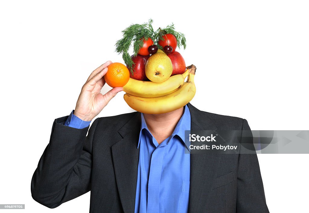 Fruity Man Businessman with a head made ​​of fruits and vegetables gives orange, healthy eating concept Peach Stock Photo