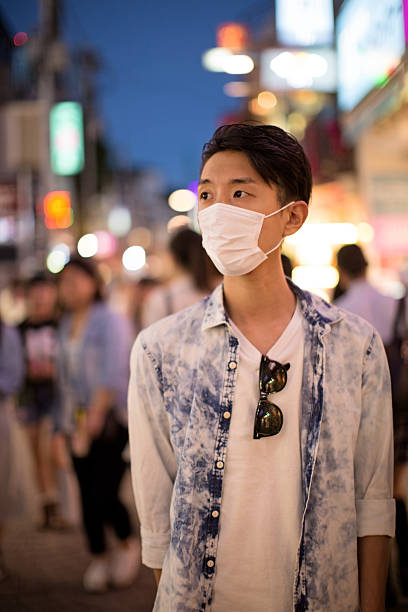istock Japanese man wearing protective mask in Tokyo 496820622