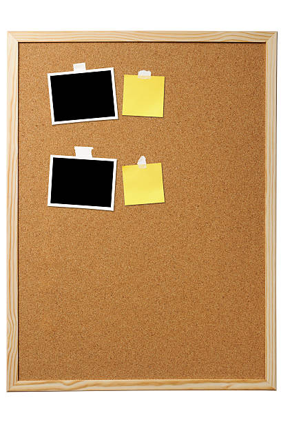 istock Attached blank photos and yellow sticky note on cork board 496824898