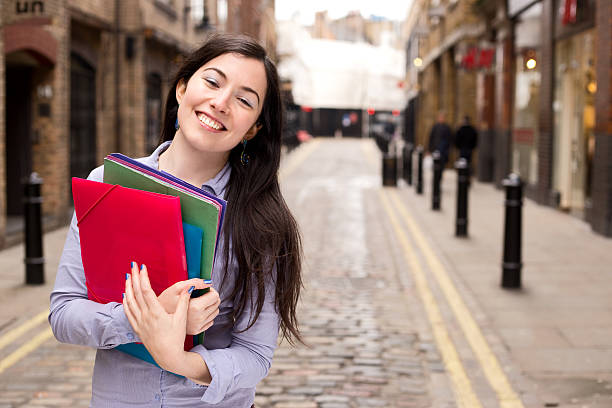 istock young woman holding folders 496824910