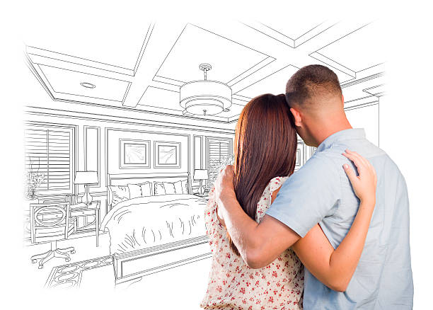 istock Young Military Couple Looking Over Custom Bedroom Design Drawing 496825474