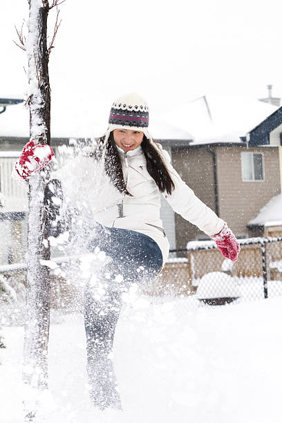 istock Young Chinese Girl Playing In Snow 496826788