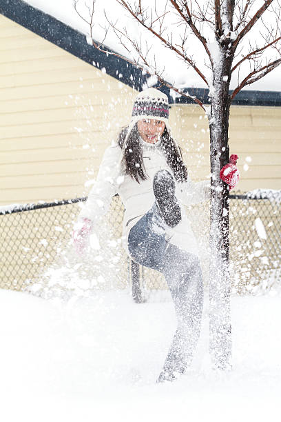 istock Young Chinese Woman Playing In Snow 496826946