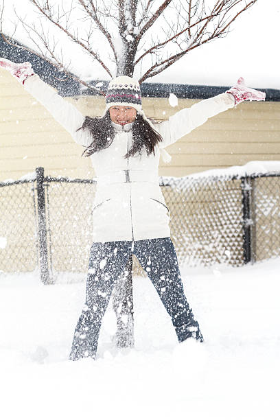 istock Young Chinese Woman Playing In Snow 496826992