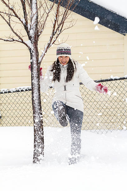 istock Young Chinese Woman Playing In Snow 496827032