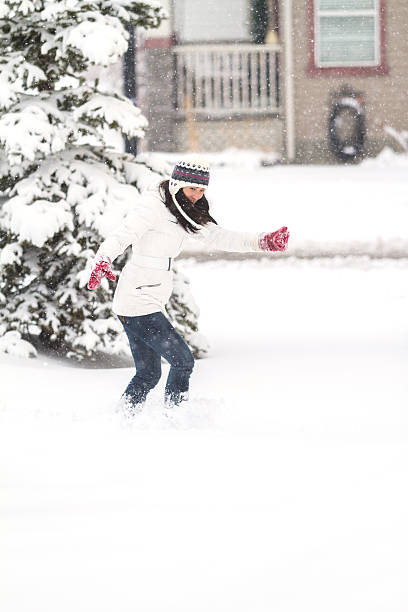 istock Young Chinese Woman Playing In Snow 496827054