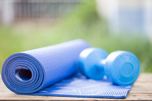istock yoga mat and dumbbell 496827734