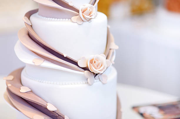 istock White wedding cake decorated with sugar flowers 496828468