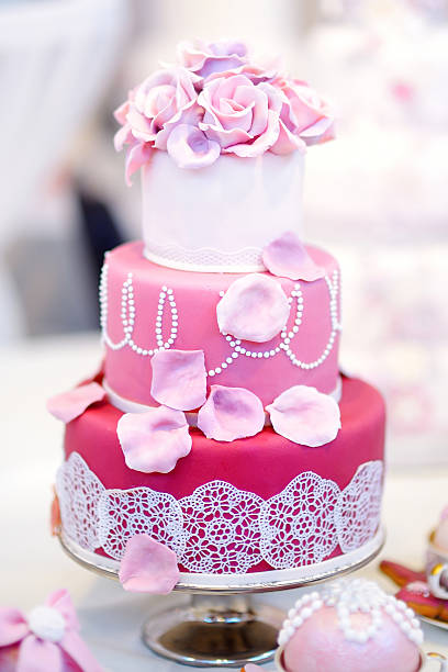 istock White wedding cake decorated with sugar flowers 496828834