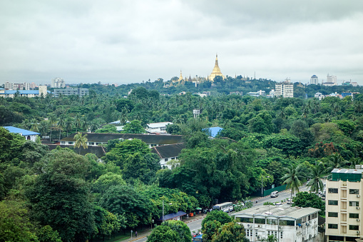 Yangon, Myanmar - October 12, 2015: View of Shwe Dagon Pagoda in downtown Yangon Myanmar.  There are still a lot of trees and green area in Yangon even the city is growing and expanding.