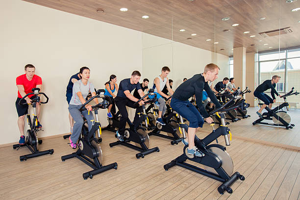 istock Group of gym people on machines, cycling In Class 496830932