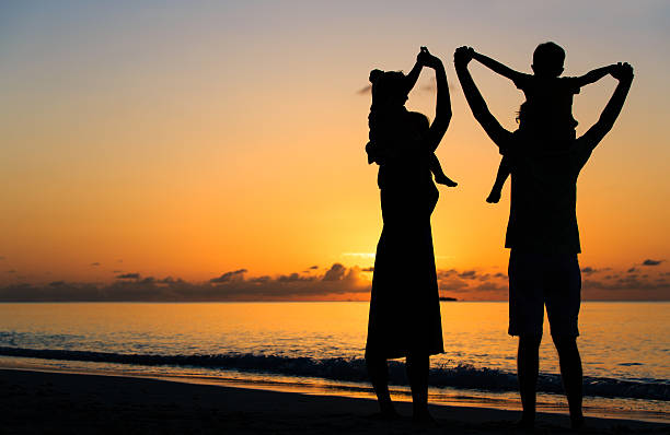 istock family with two kids having fun on sunset beach 496833158