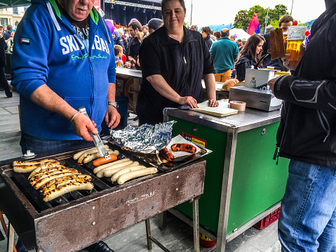 Zurich, Switzerland - May 1, 2014: People buying hot dogs on Zurich street
