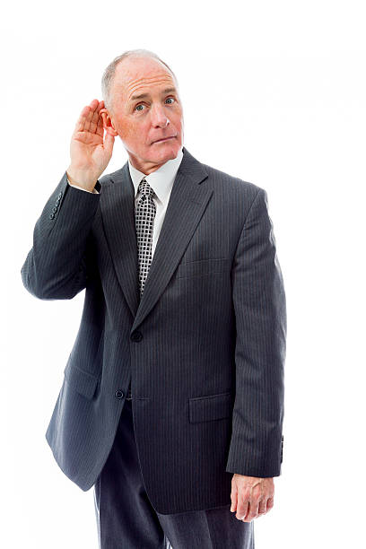 Businessman trying to listen isolated on white background Businessman trying to listen isolated on white background old man cupping his ear to hear something stock pictures, royalty-free photos & images