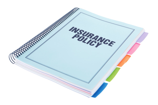 Insurance Policy - Large bound business documents in book form with dividers with a blue cover - isolated on a white background.  Paperwork on white.