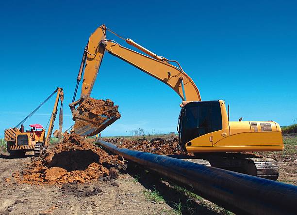 istock Excavator open trench for pipe laying pipeline 496837753