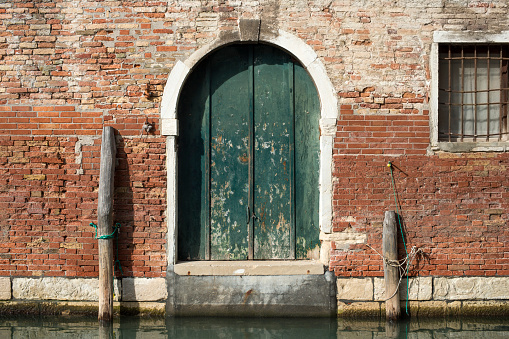 ancient building entrance directly from water channel in Venice, Italy