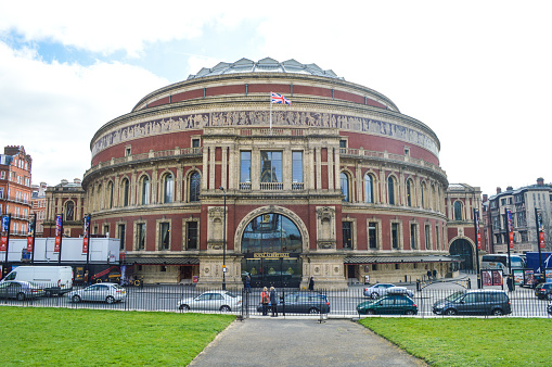 London, UK - March 22, 2015: Royal Albert Hall. Photo taken during the day and contains several tourists and some motorized traffic.