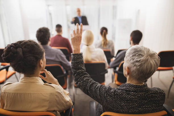 istock Back view of a businesswoman asking a question on seminar. 496851962