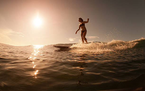 istock The girl with surf at sunrise 496852219