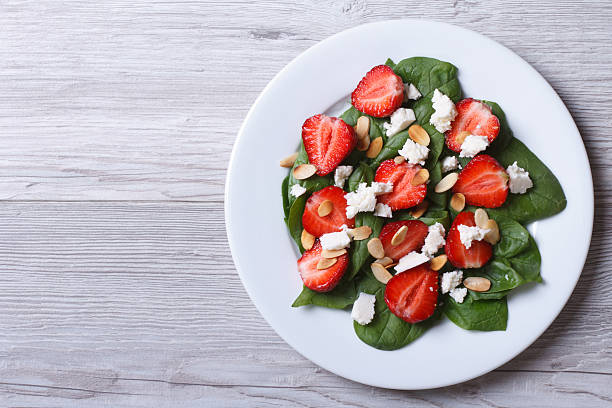 istock Salad of spinach, strawberries, cheese and almonds 496854549