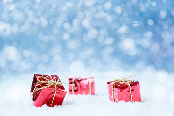 istock Red Christmas Presents on Snow Background 496854770