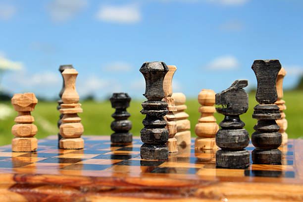 istock Image of chessboard game / wooden chess set against sky, boardgame 496856835