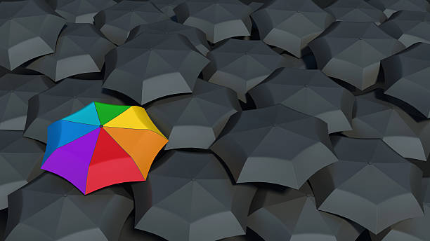 istock umbrella with rainbow colors against the black umbrellas 496858775