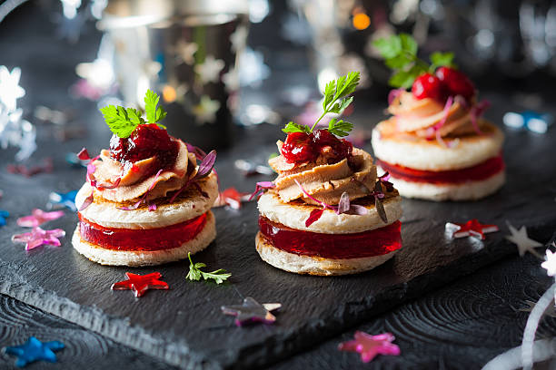 Foie gras and cranberry chutney Festive appetizer with foie gras, cranberry chutney and jelly canape stock pictures, royalty-free photos & images