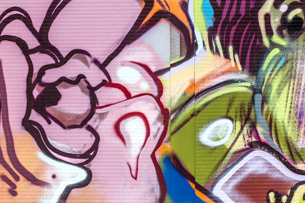 Color image of a wall that has graffiti designs on it.