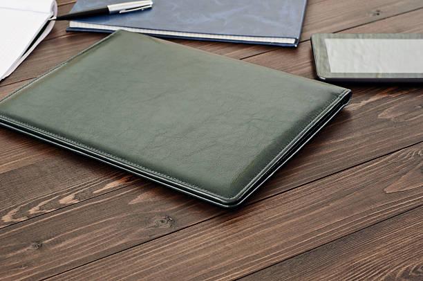 istock Business leather folder on the office desk close up 496873684