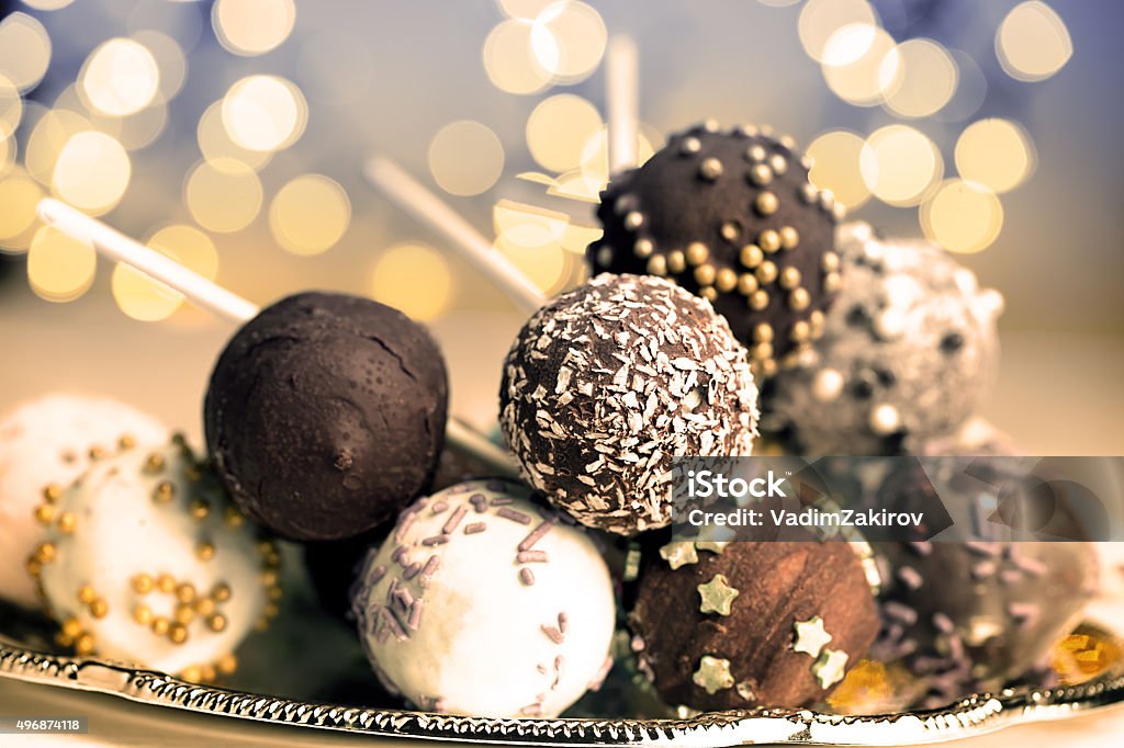 Colorful cake pops Colorful cake pops on the blurred yellow bokeh background Chocolate Stock Photo