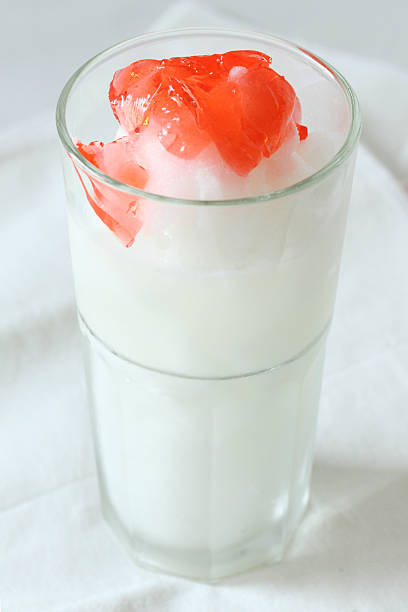 glass of lime smoothies drinks with red jelly