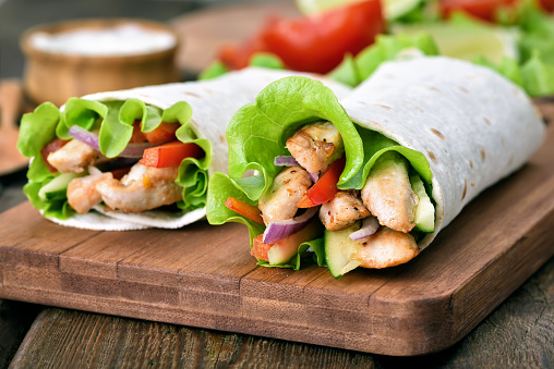 Wrap sandwiches with chicken meat and fresh vegetables, close up view