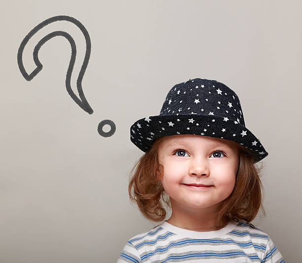 Thinking cute kid with big question sign above looking up