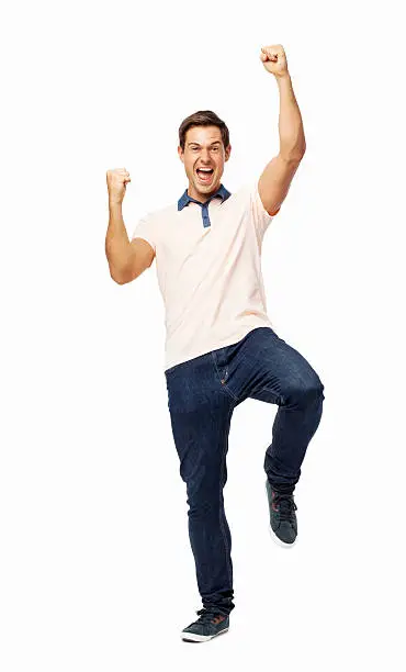 Full length portrait of young man celebrating success over white background. Vertical shot.
