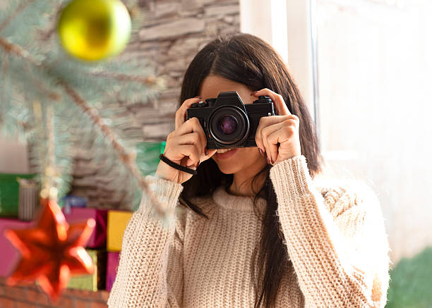 istock Beautiful smiling girl with old camera 496878792
