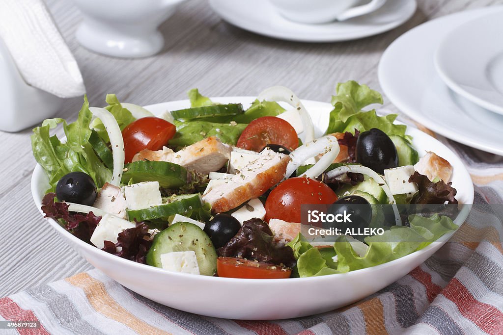 Salad with chicken, tomatoes, cucumbers, onions and cheese Salad with chicken, tomatoes, cucumbers, onions and cheese on the table. horizontal. Appetizer Stock Photo
