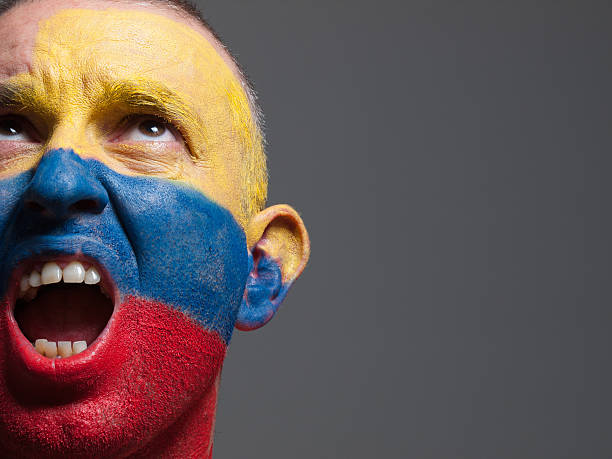 istock Man face painted with colombian flag. 496879251