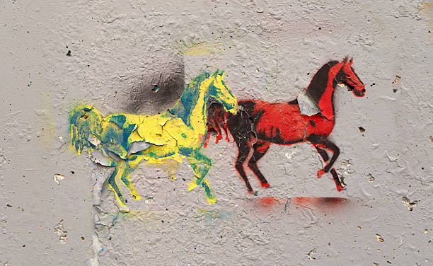 istock Graffiti of two horses peeling on concrete 496881065