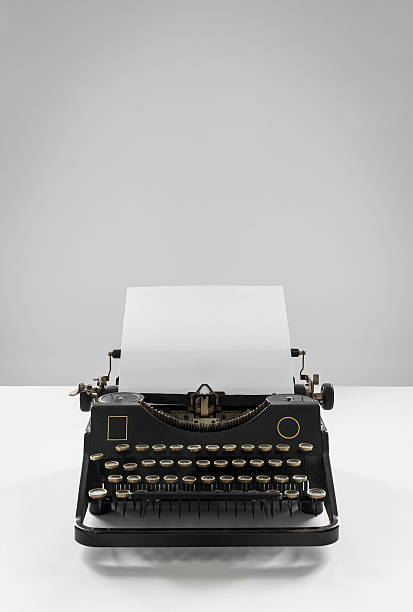 istock Old vintage black typewriter with empty sheet of paper 496882216