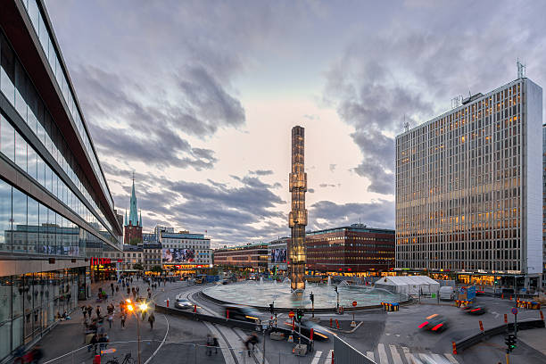 Stockholm, Sweden - September 18, 2015: People walking around the Sergel Square in the heart of Stockholm during dusk time. Sergel Square is a very central square with close to department store, shops, restaurants and is also adjacent to a cultural house with library and theatre.