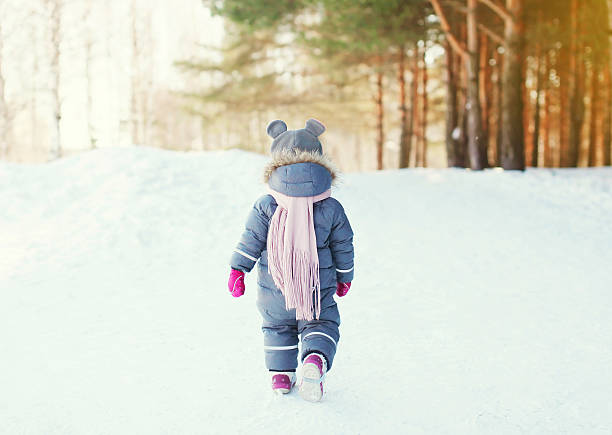 istock Silhouette little child walking in forest on a winter day 496882408