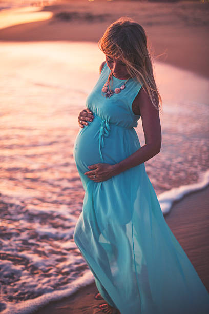 istock Pregnant woman on the beach 496884700